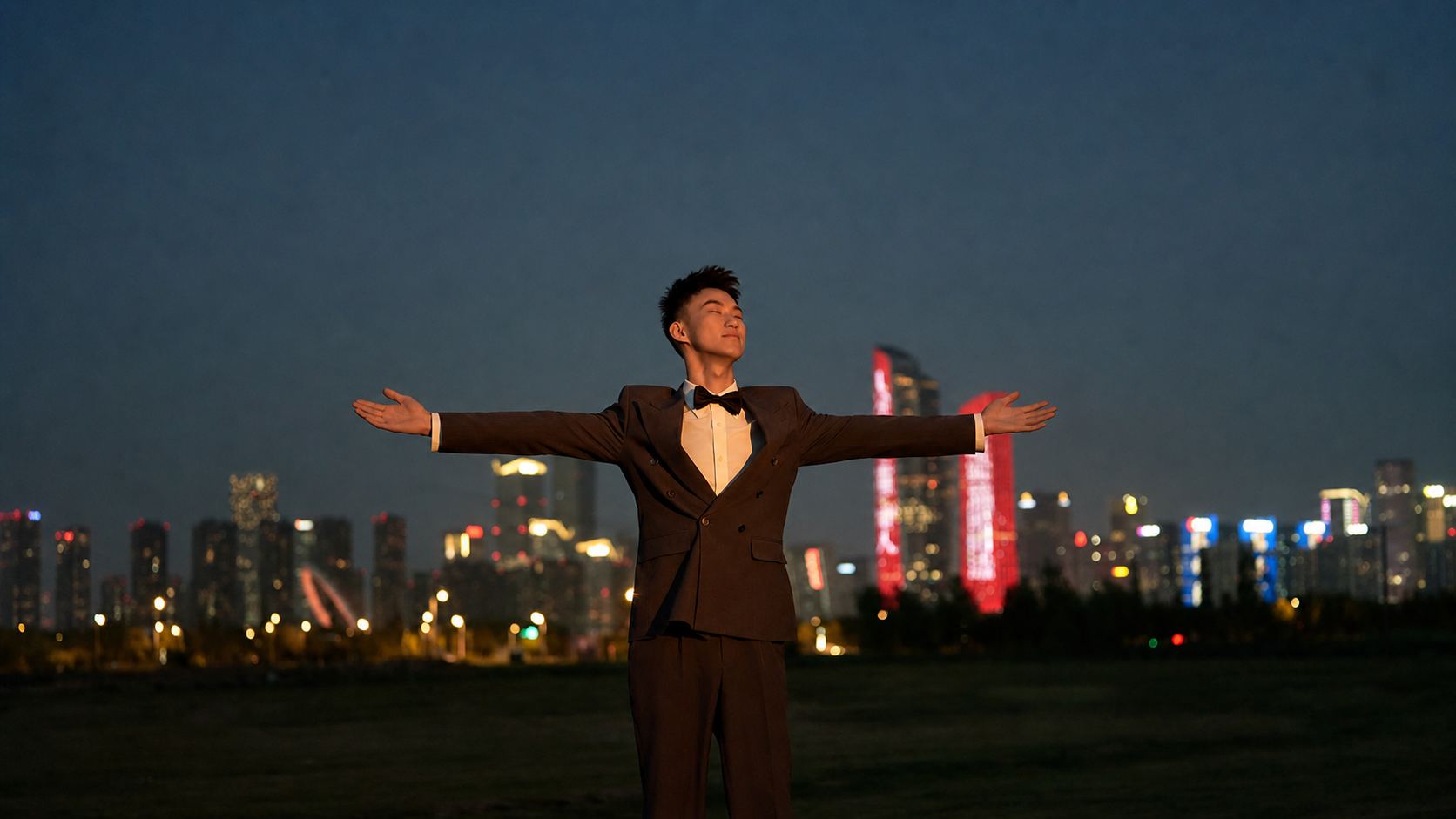 JD in front of a modern city skyline